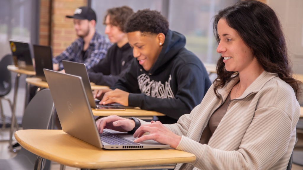 Students sitting at desks on their laptops